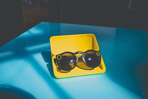 neonbrand digital marketing black sunglasses in yellow case on table las vegas